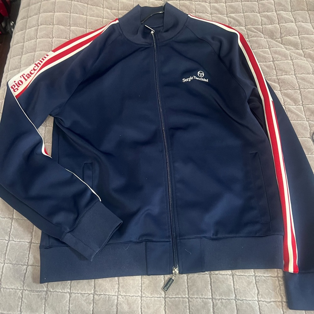Dark blue with red and cream stripes. Sergio track suit